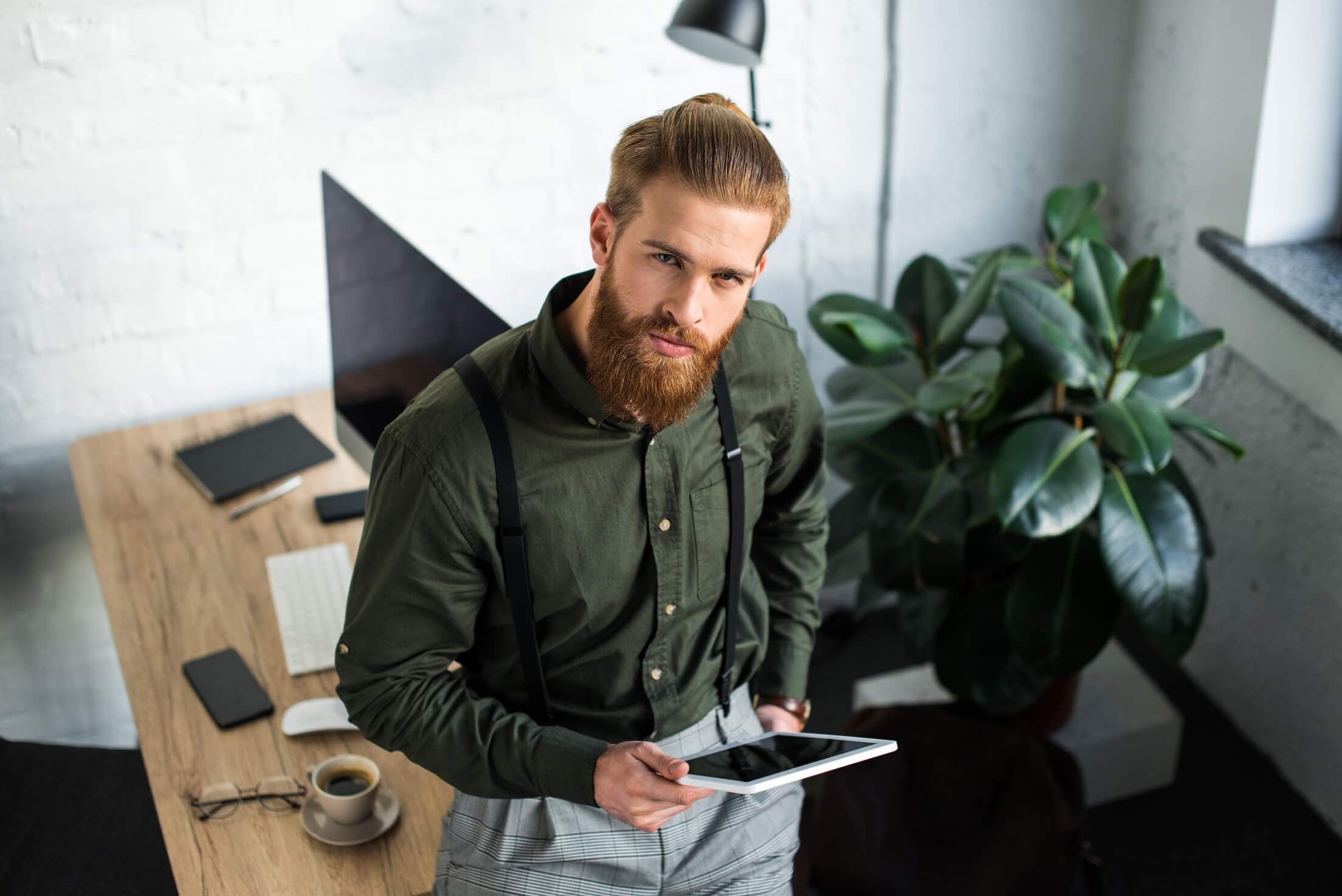 overhead view of businessman holding tablet and lo mr9lqpj.jpg